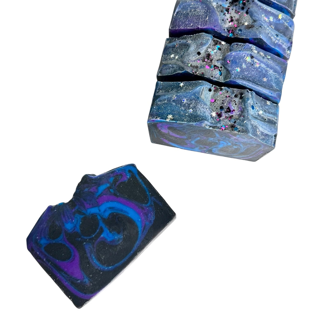 After Dark handmade galaxy soap bars with swirled purple, blue, and black design topped with glittery stars
