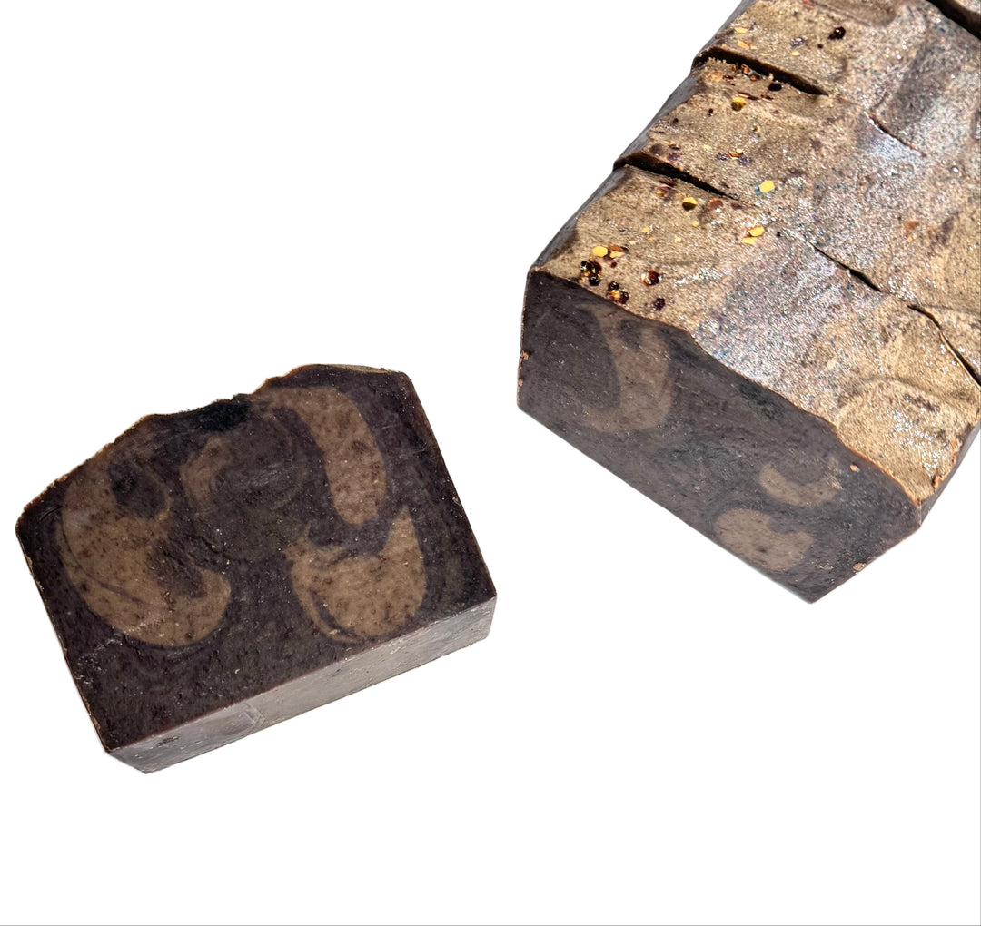 Handcrafted artisan soap bar with rich golden-brown swirls and a shimmering top, inspired by bourbon and butterscotch, Sugar Daddy by Dirty Little Suds.