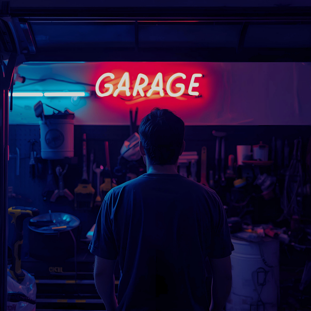 Neon garage sign with tools in the background for Dirty Little Suds Men’s Collection