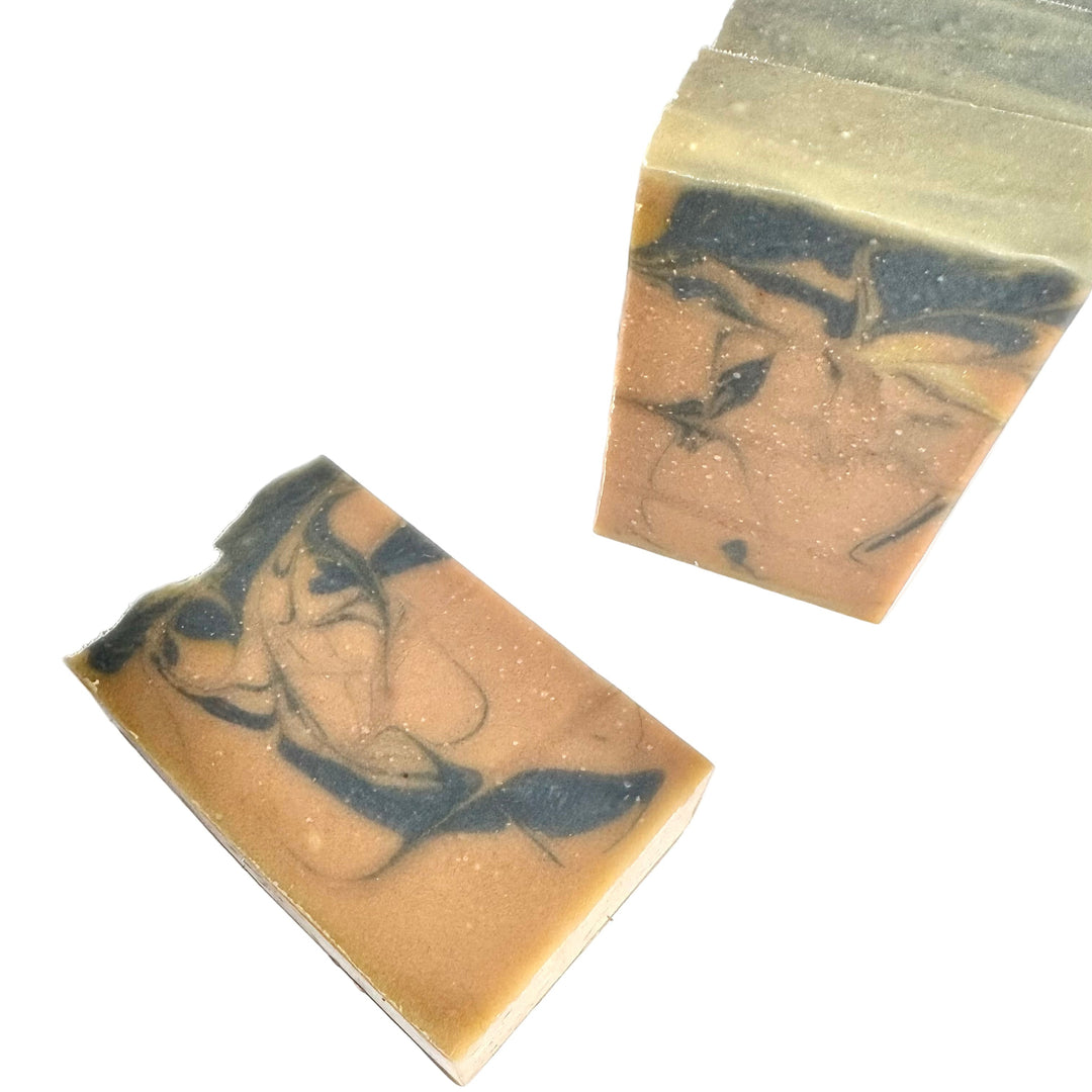 Aged Sandalwood handmade soap by Dirty Little Suds with warm brown and black swirls, scented with sandalwood and leather.