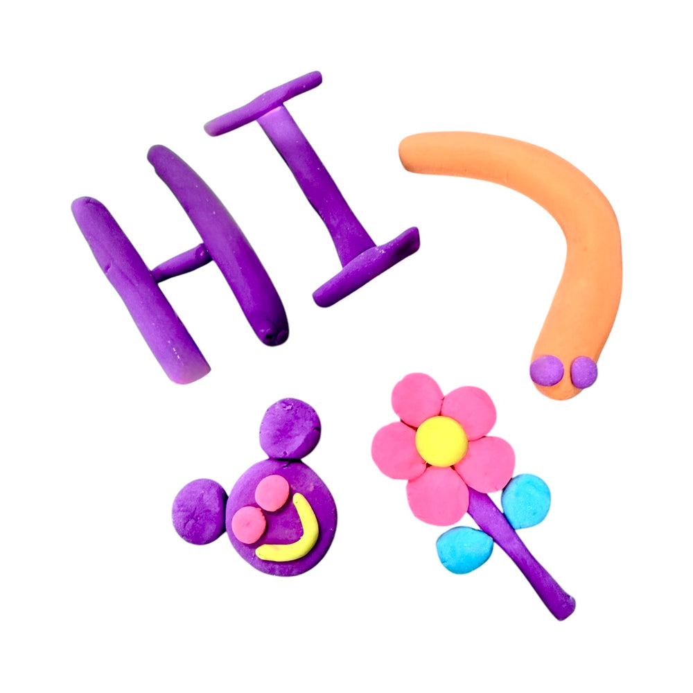 Colorful Bubble Dough shaped into playful designs including the word “HI,” a smiley face, and a flower, showing the soft, moldable texture of the reusable bath dough.