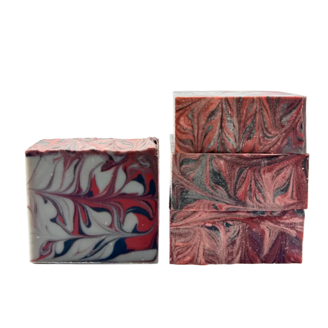 Delusionally Confident Soap handmade by Dirty Little Suds with a gorgeous Taiwan Swirl of dark red, black, and grey.