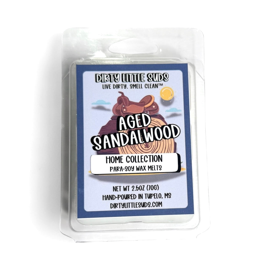 Clamshell pack of Dirty Little Suds Aged Sandalwood wax melt with a retro-inspired label. A smooth, sophisticated fragrance of warm sandalwood with subtle leather undertones for a bold, timeless clean.