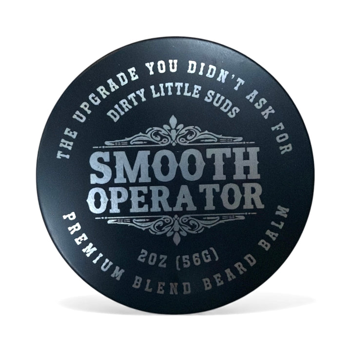 Dirty Little Suds Smooth Operator Beard Balm tin, black matte packaging with silver lettering. Deep, musky blend that hydrates, styles, and defines beards without shine.