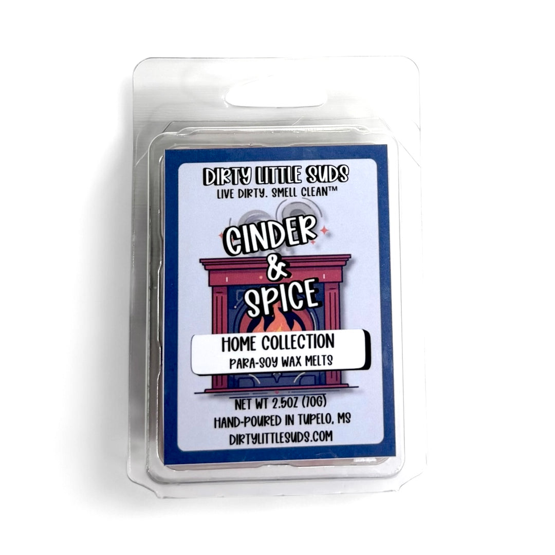 Clamshell pack of Dirty Little Suds Cinder & Spice wax melt with a retro-inspired label. A warm, inviting fragrance with smoky undertones and a blend of autumn spices for a cozy, comforting vibe.