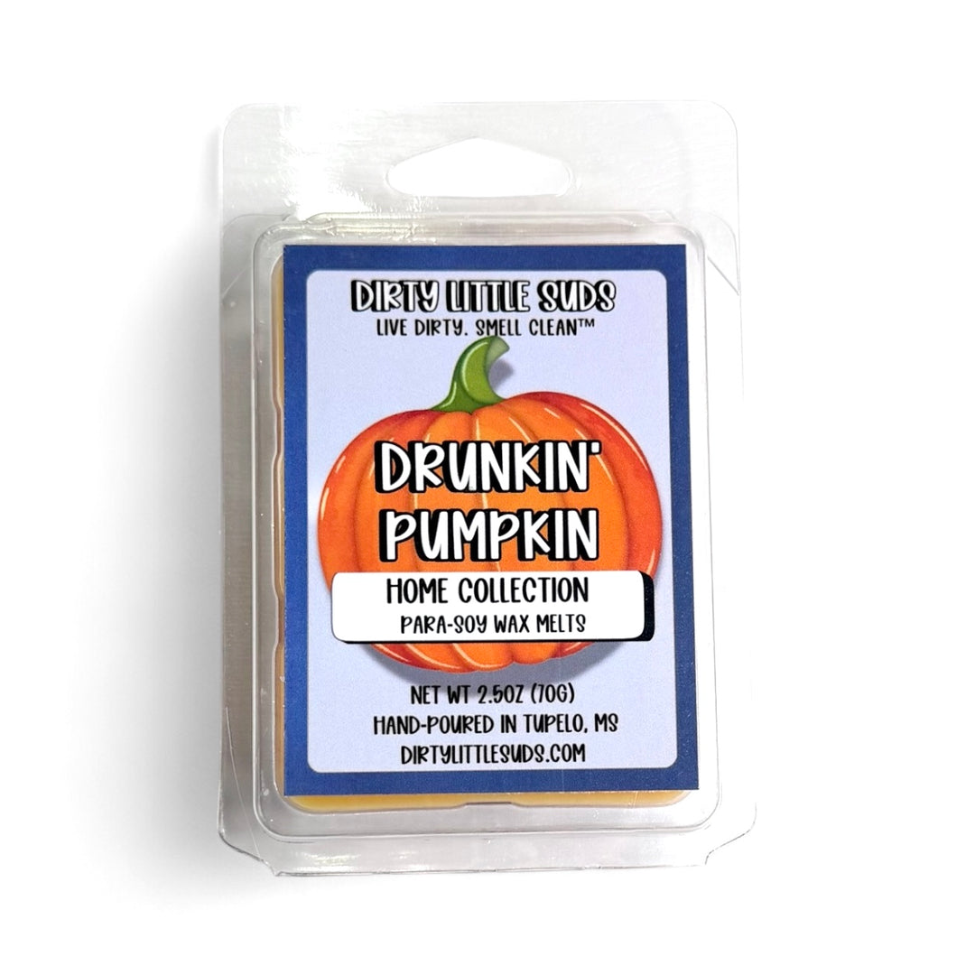 Clamshell pack of Dirty Little Suds Drunkin’ Pumpkin wax melt. Deep orange wax with a retro-inspired label in bold black and orange. A cozy fall fragrance blending pumpkin, spice, and a playful boozy twist for autumn vibes.