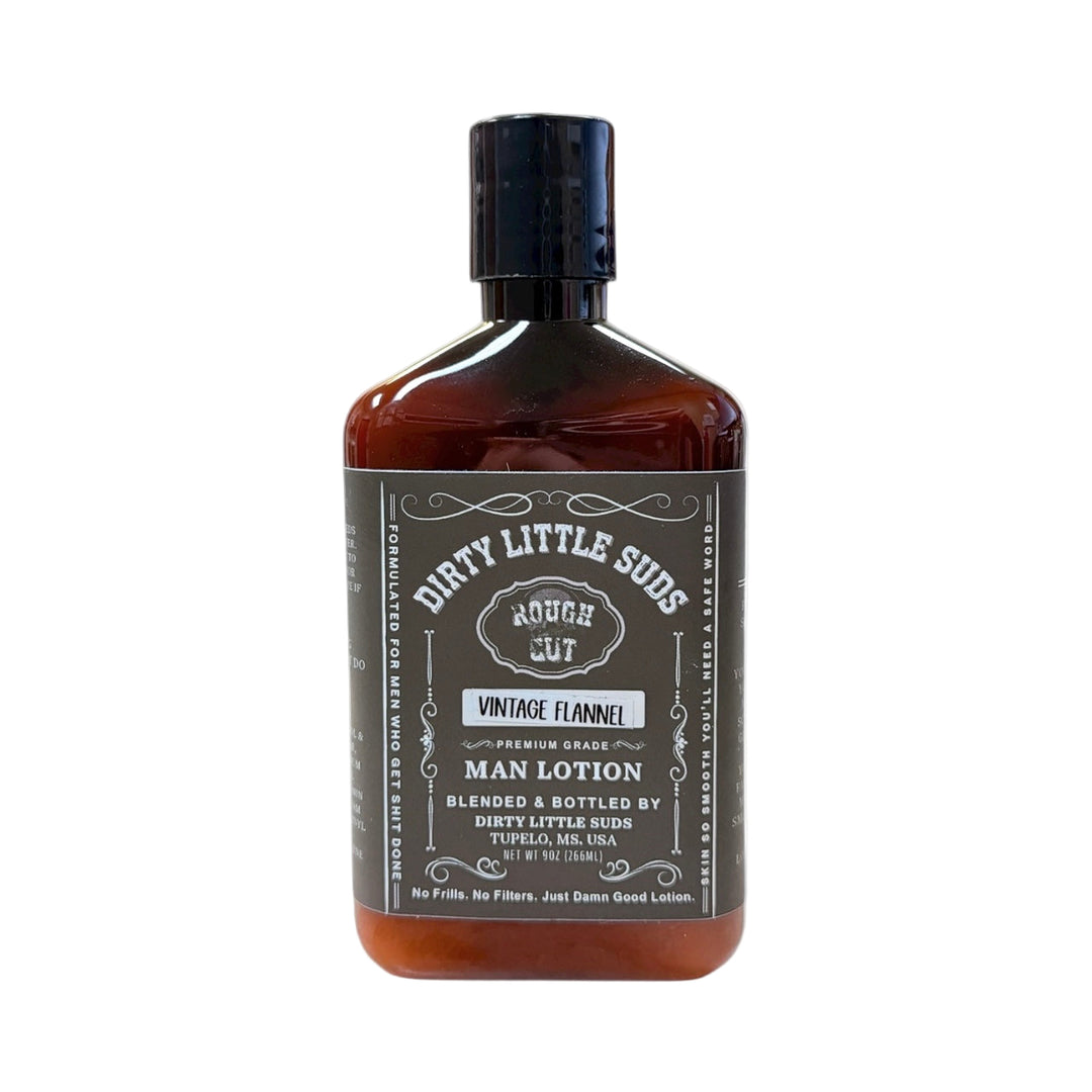 Dirty Little Suds Rough Cut Men’s Lotion in Vintage Flannel scent, amber bottle with black label. Warm woods and chilled vanilla men’s lotion that feels rugged and refined.