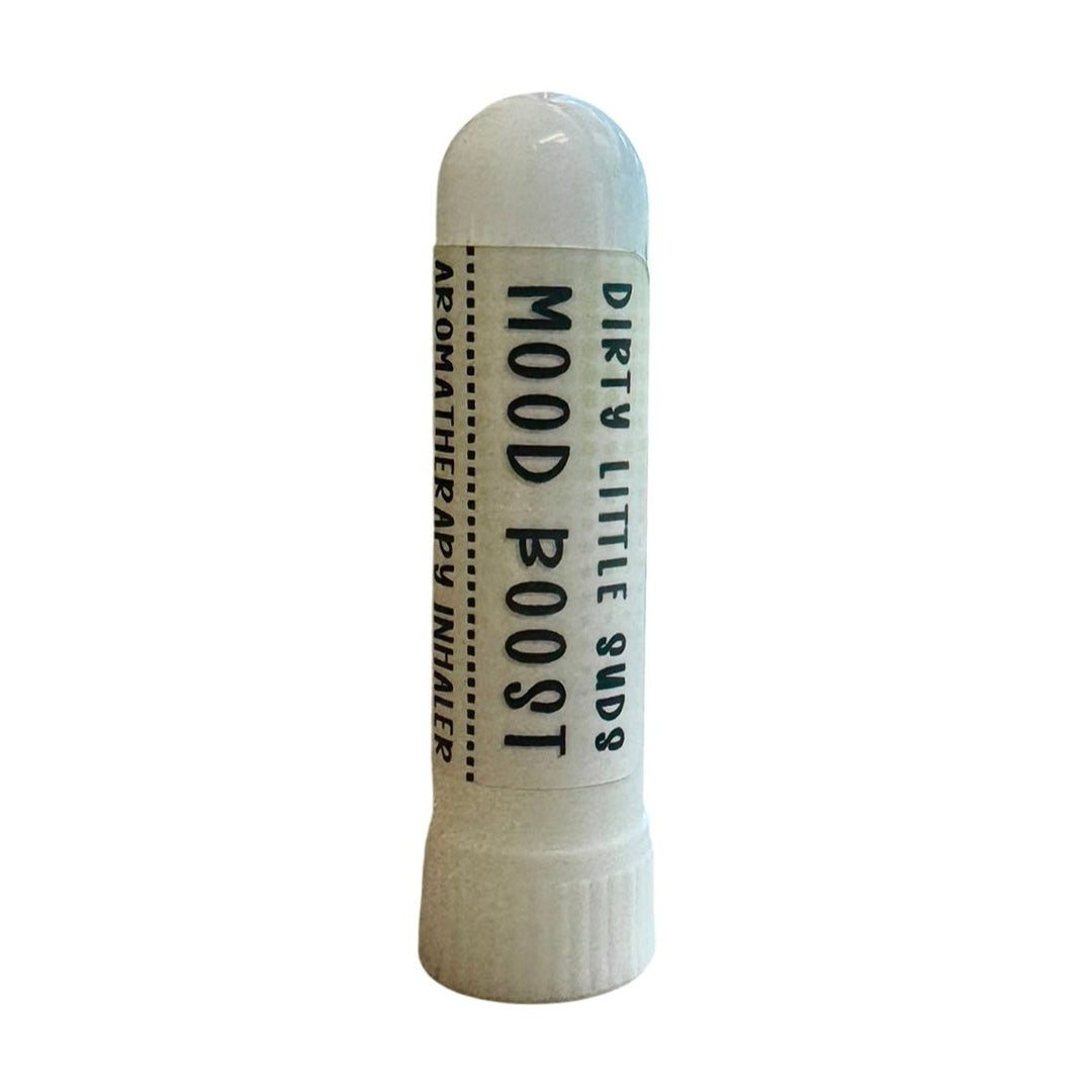 Close-up of Dirty Little Suds Mood Boost Aromatherapy Inhaler, pocket-sized essential oil inhaler with orange, grapefruit, lavender, spearmint, and cedarwood oils for natural energy and clarity.