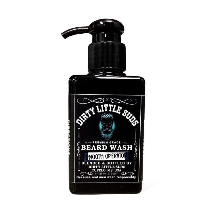 Dirty Little Suds Smooth Operator Beard Wash in a sleek black pump bottle with white retro design and turquoise beard logo. A sulfate-free men’s beard wash for a clean, soft, touchable beard.