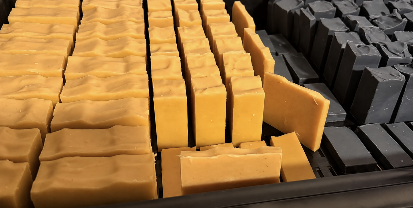 Photo of handmade soap from Dirty Little Suds on a soap curing tray
