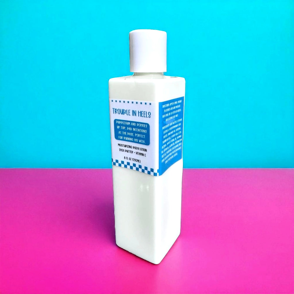 White rectangular 8oz bottle with a bright blue retro label reading “Bubblegum and berries up top. Bad intentions at the base. Perfect for ruining his week.” Shot on a turquoise and hot pink background.