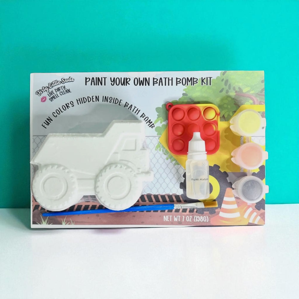 Dirty Little Suds Paint Your Own Bath Bomb Kit – truck bath bomb with hidden colors, paint set, pop-it toy, and brush displayed against teal background.