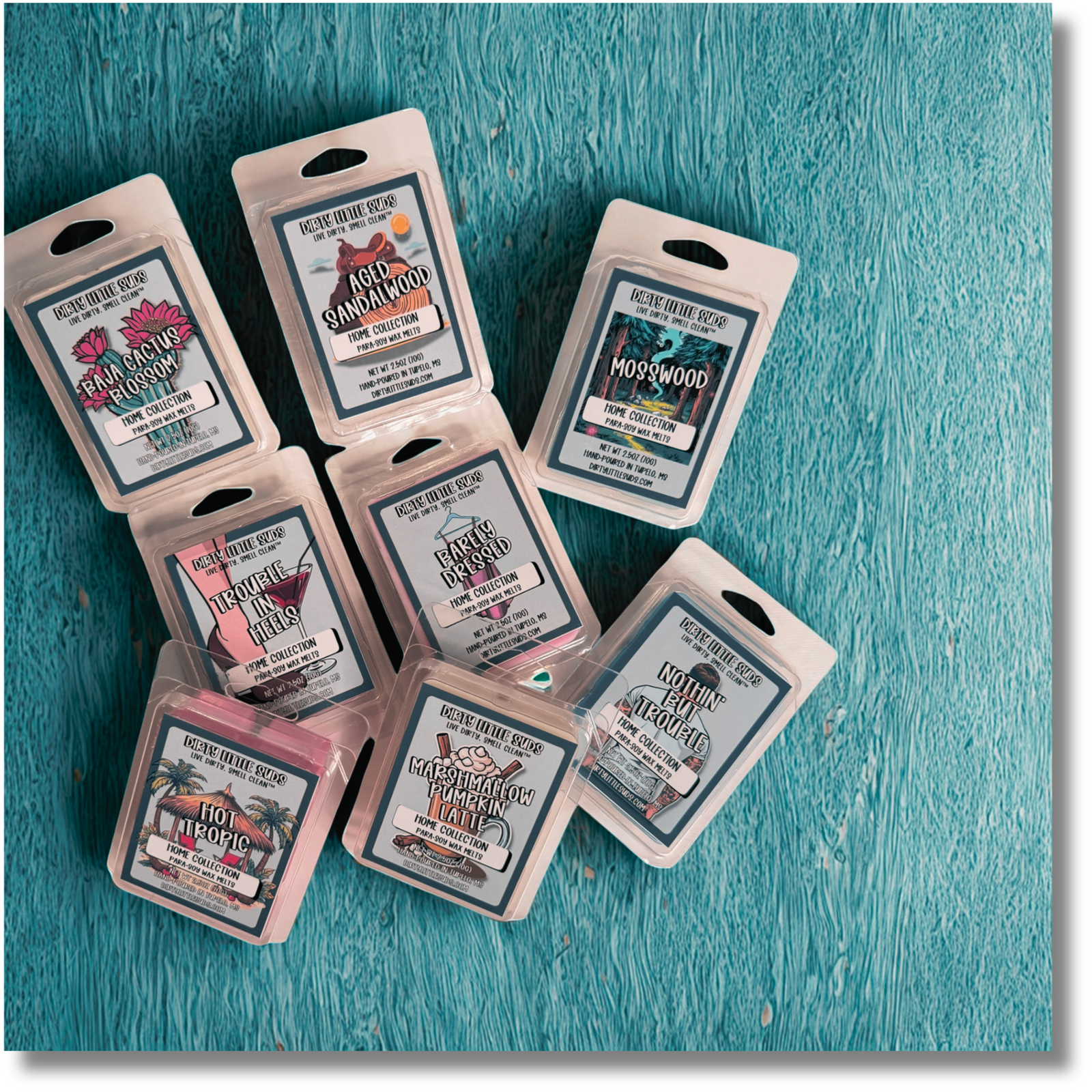 Flat lay of Dirty Little Suds wax melts in assorted scents including Hot Tropic, Marshmallow Pumpkin Latte, Trouble in Heels, Barely Dressed, Baja Cactus Blossom, Aged Sandalwood, Mosswood, and Nothin’ But Trouble displayed on a turquoise background. Perfect for mix and match wax melt bundles.