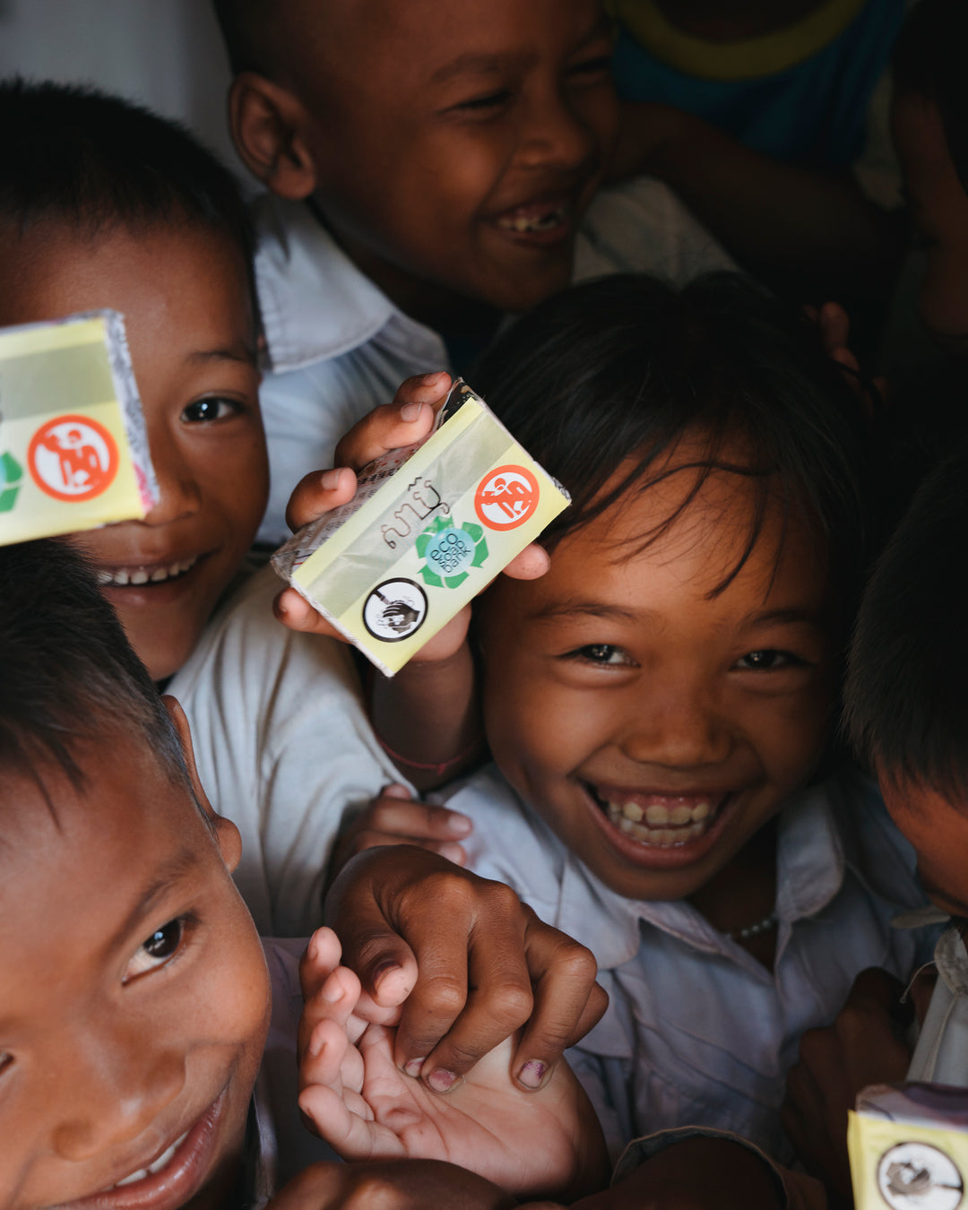 Children holding recycled bars of soap distributed through Eco-Soap Bank programs