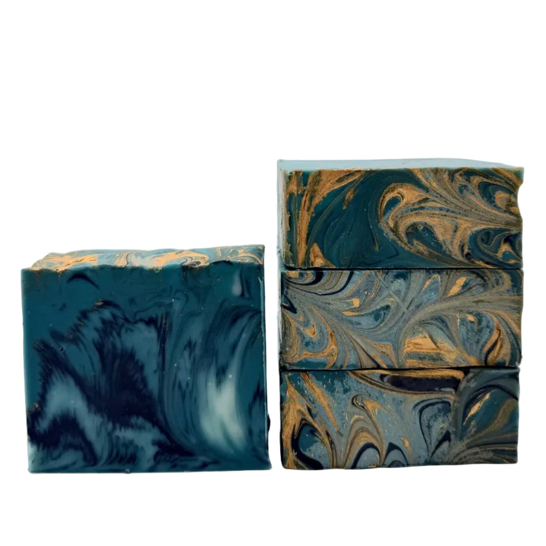 Filthy Rich handmade soap with deep teal, blue and metallic gold swirls, scented with sandalwood, leather, cedarwood and cardamom handmade by Dirty Little Suds