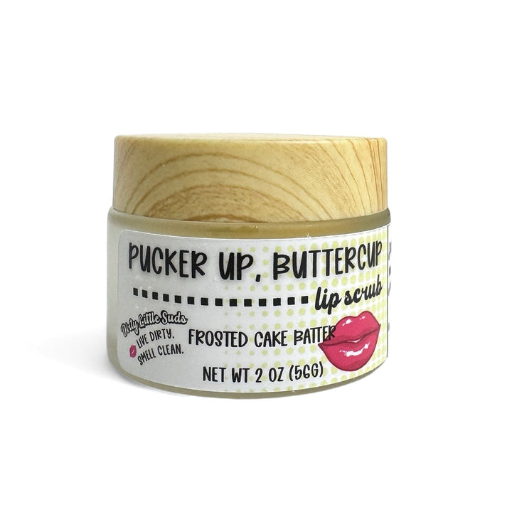 Dirty Little Suds “Pucker Up, Buttercup” Frosted Cake Batter sugar lip scrub (2 oz). Dessert-inspired lip exfoliator that polishes flakes and boosts shine; coconut oil, shea butter, almond oil, vitamin E.