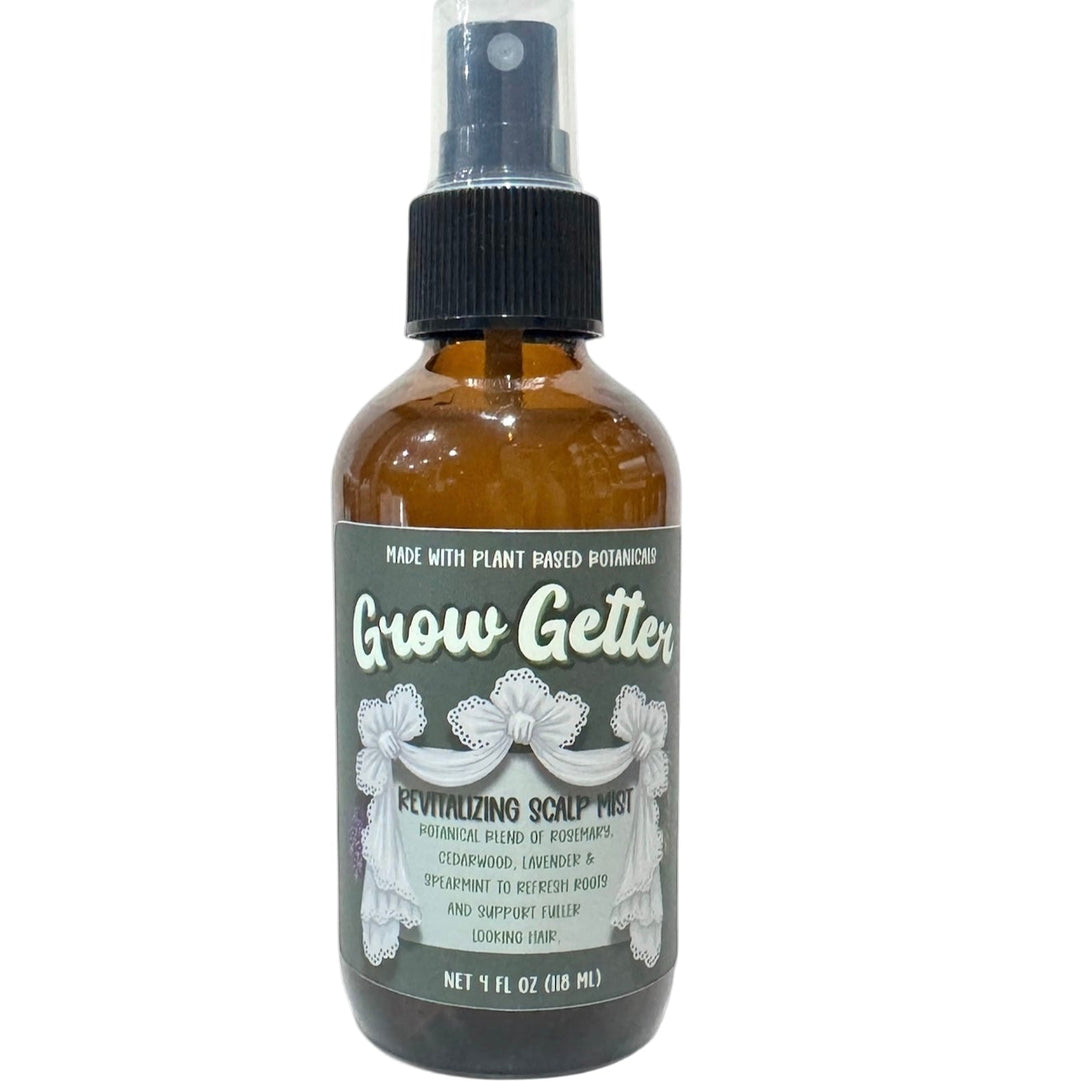 4oz amber spray bottle of Grow Getter Revitalizing Scalp Mist on plain background with Dirty Little Suds label.