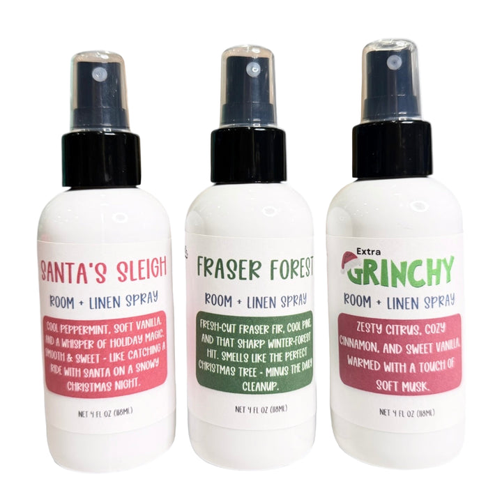 Three Dirty Little Suds Holiday Room + Linen Sprays – Santa’s Sleigh, Fraser Forest and Extra Grinchy – 4oz white bottles with black spray tops on a white background, Christmas scent trio product image, Dirty Little Suds