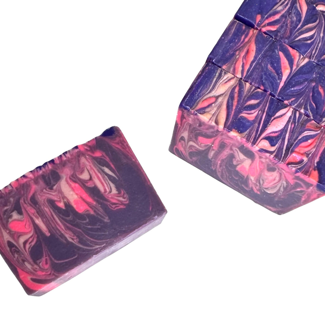 Honey, Hush handmade soap bars with deep purple and magenta swirls; single bar and sliced loaf at an angle