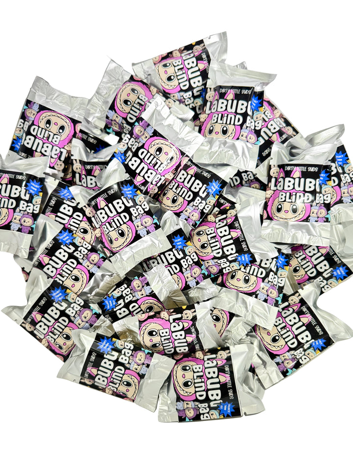 Pile of shiny silver Labubu Blind Bags from Dirty Little Suds, Series 1 collectible mystery packaging.