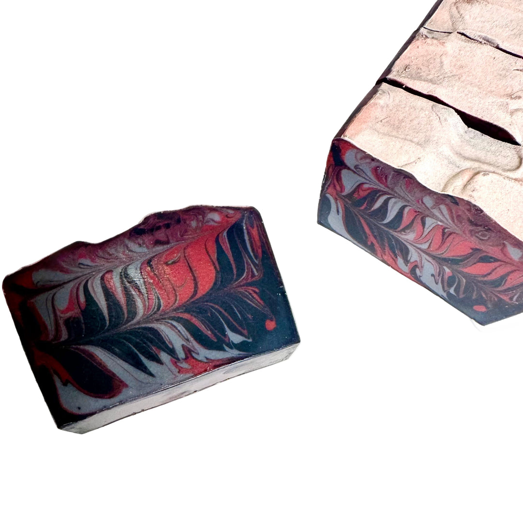 Handcrafted artisan soap bar with dark wood-inspired swirls of black, gray, and cream, scented with mahogany teakwood, Man Cave by Dirty Little Suds.