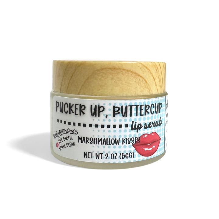Dirty Little Suds “Pucker Up, Buttercup” Marshmallow Kisses exfoliating sugar lip scrub (2 oz). Buffs dry skin, nourishes, and leaves lips kiss-ready; coconut oil, shea butter, almond oil, vitamin E.