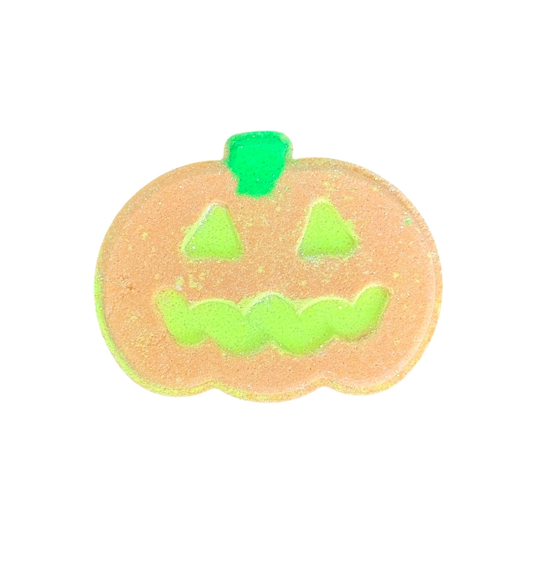 Pumpkin-shaped Halloween bath bomb with Cursed Cranberry scent, neon yellow eyes, and hidden color embeds. Tub-safe fizz, vegan, and handmade.