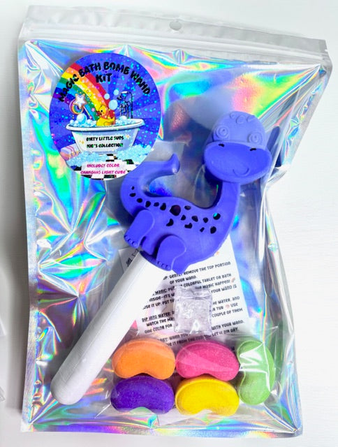 Purple dinosaur bath bomb kit by Dirty Little Suds, includes starter pack of jelly bean bath bombs and color changing light cube packaged in a gift ready bag.