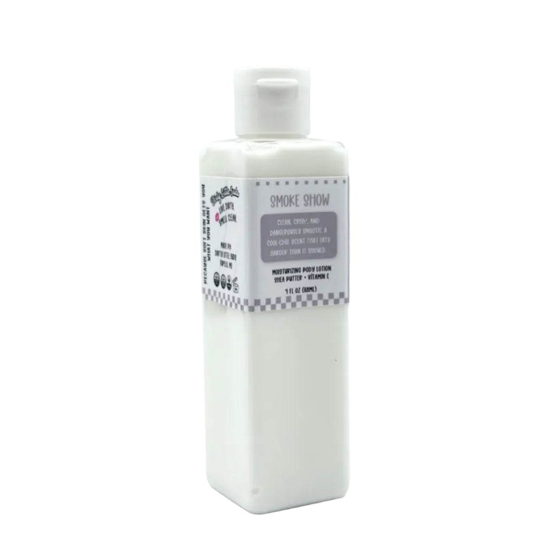 White rectangular 4 oz Dirty Little Suds body lotion bottle labeled Smoke Show with grey retro checkered design on a clean white background