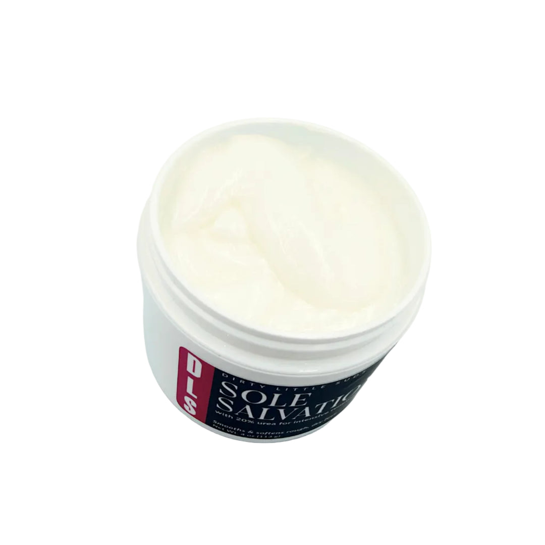 Open white jar of Sole Salvation 20% Urea Foot Cream showing the thick white cream inside, with the black and turquoise Dirty Little Suds label visible against a white background.