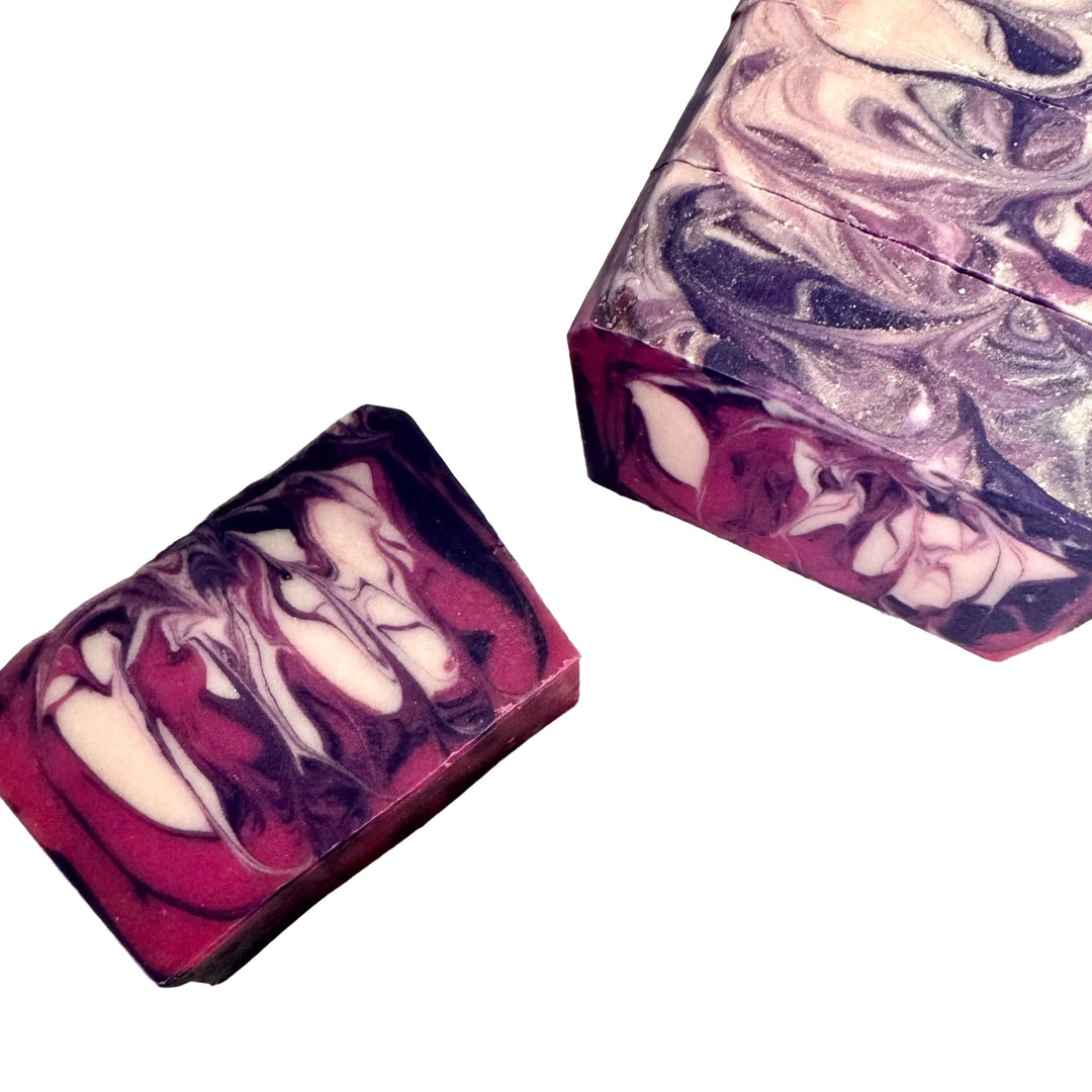 Handcrafted artisan soap bar with dramatic berry, black, and cream swirls, scented with black currant and absinthe, Spellbound by Dirty Little Suds.