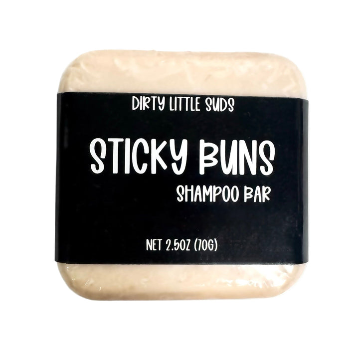 Dirty Little Suds Sticky Buns shampoo bar with black label, shown front-facing on a clean white background, 2.5 oz size.