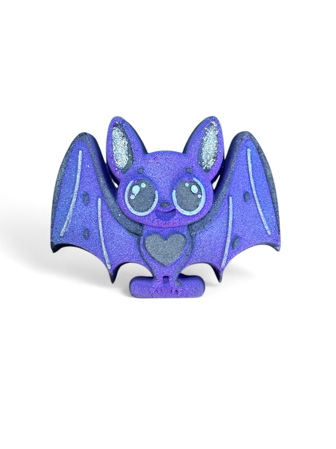 Bat-shaped bath bomb with cotton candy scent, glittered ears, and hidden color embeds. Kid-friendly, hand-painted, and tub-safe fizz.