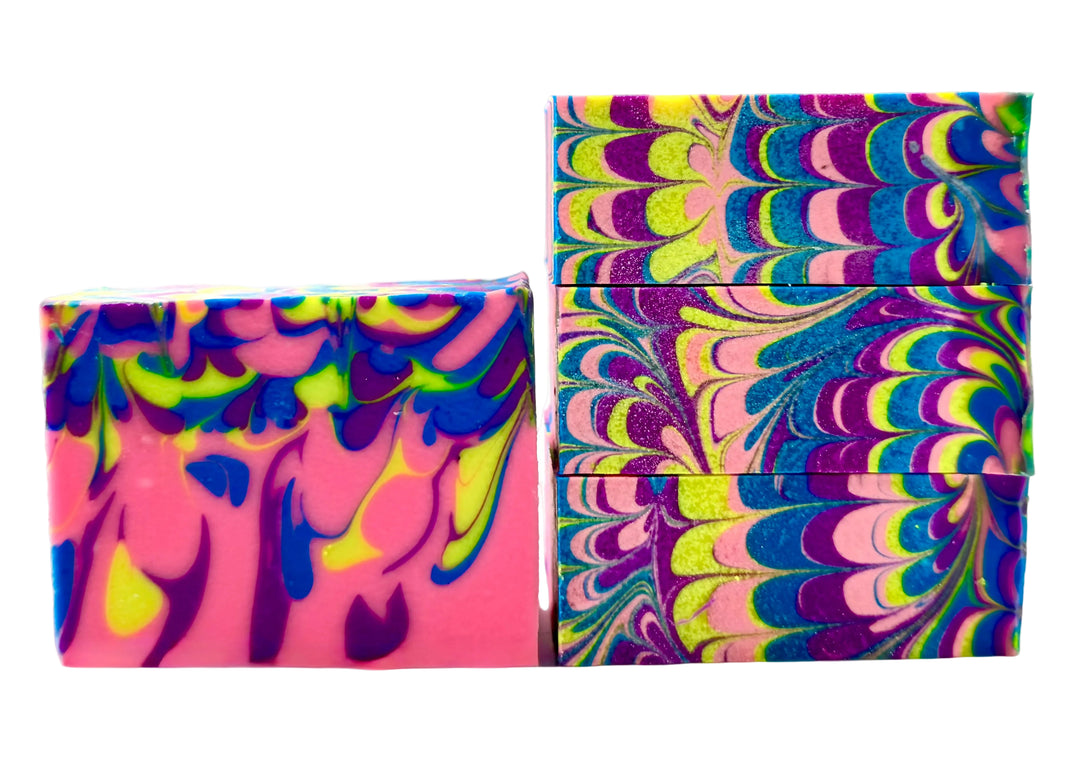 Bright neon swirl handmade soap bars in pink, purple, blue, yellow, and green with bold feathered swirl pattern