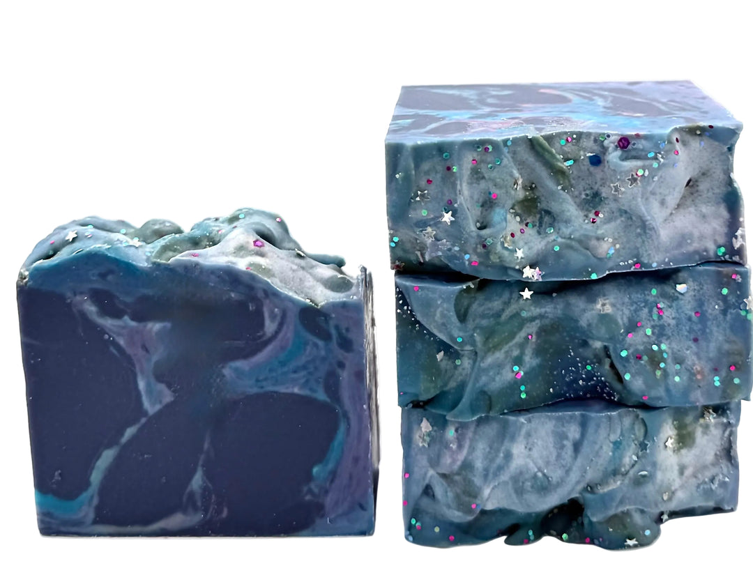 Dark blue and teal handmade soap bars with marbled swirl and colorful star-shaped glitter